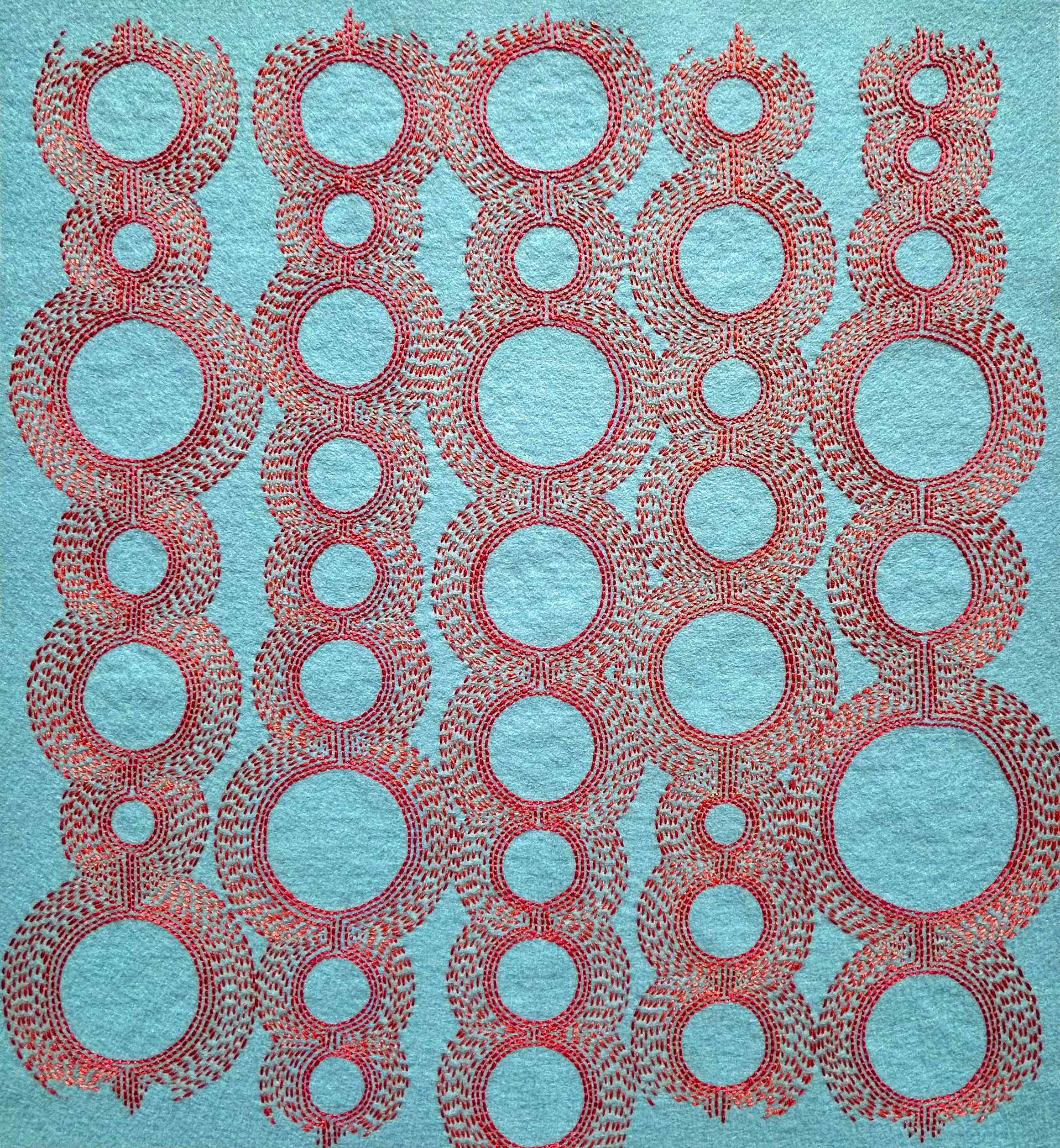 Photo of art coral and salmon thread on light blue felt