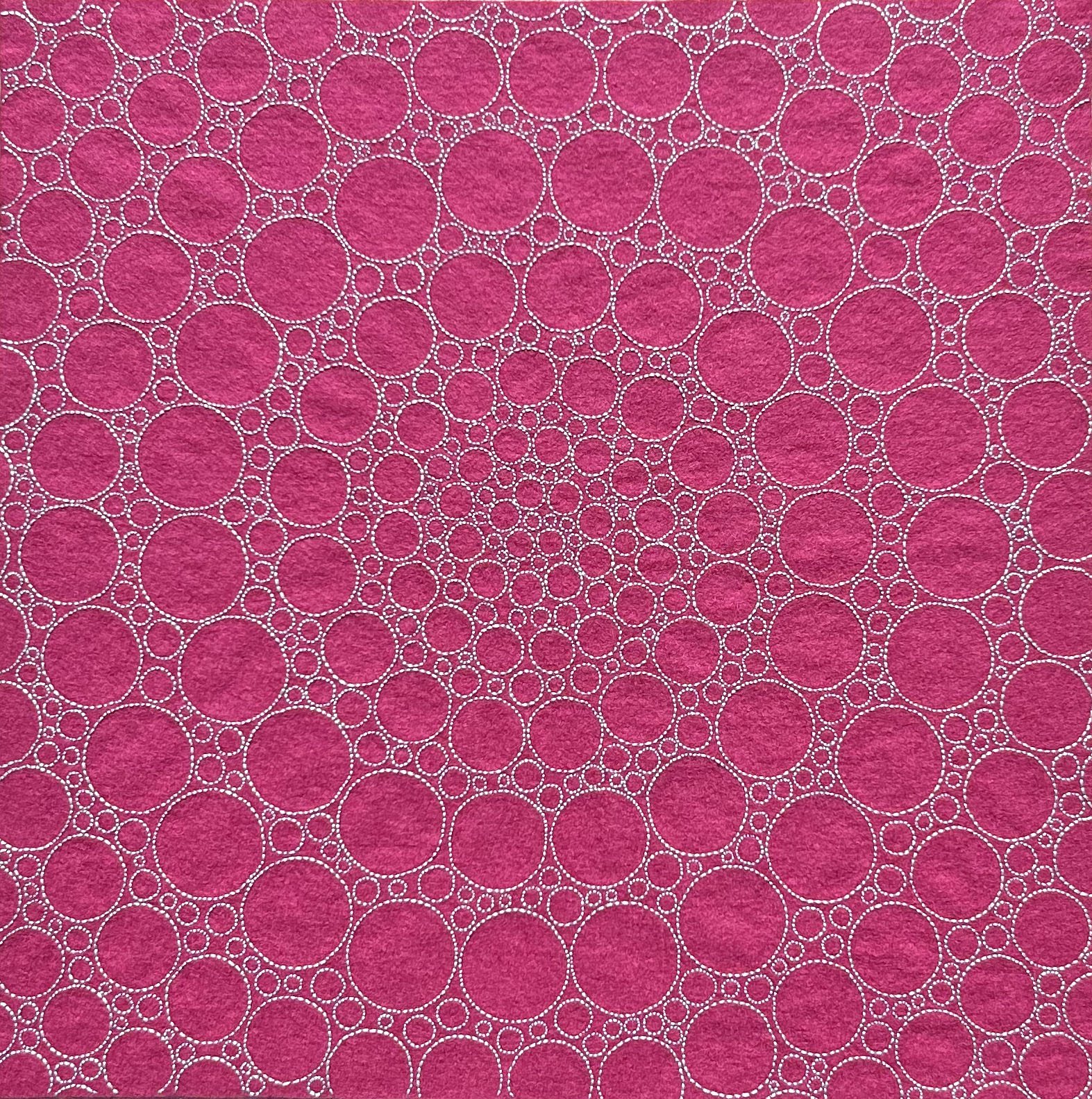 Photo of art light blue thread on magenta felt